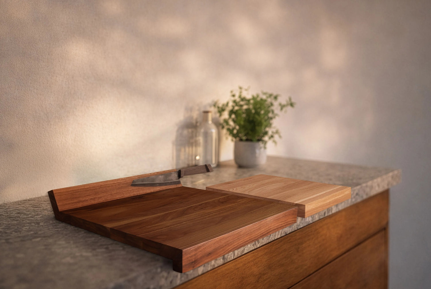 Woodsea Edge Cutting Board styled on a kitchen counter beside a small potted plant